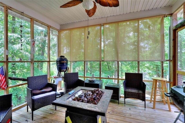 sunroom featuring ceiling fan and a wealth of natural light