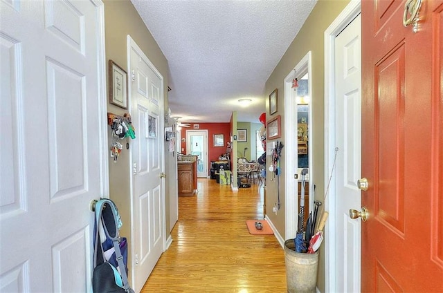 entryway featuring light hardwood / wood-style floors and a textured ceiling