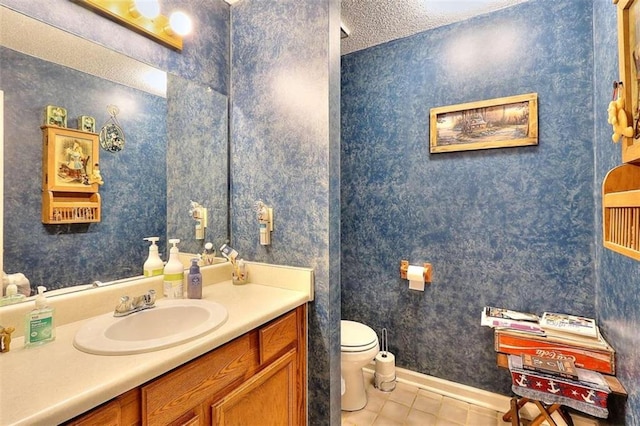 bathroom with tile floors, a textured ceiling, toilet, and vanity with extensive cabinet space