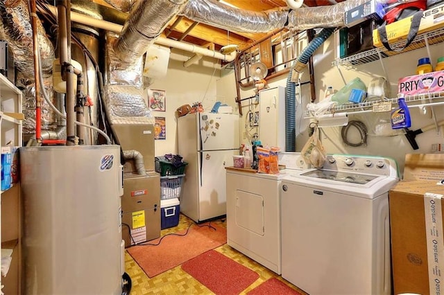 laundry area with washer and dryer and electric water heater