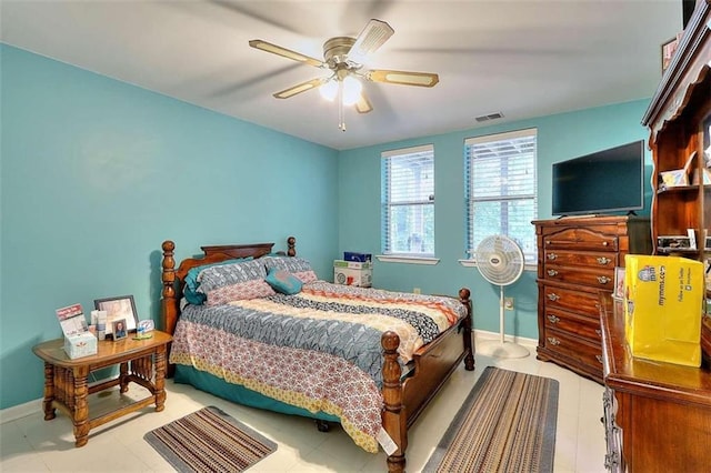 tiled bedroom featuring ceiling fan