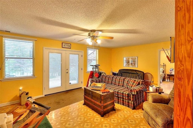 interior space with french doors, carpet flooring, ceiling fan, and a textured ceiling