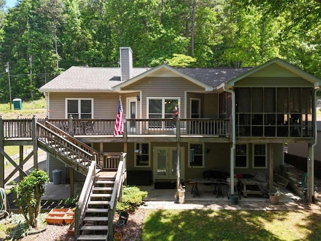 back of property featuring a patio area and a wooden deck