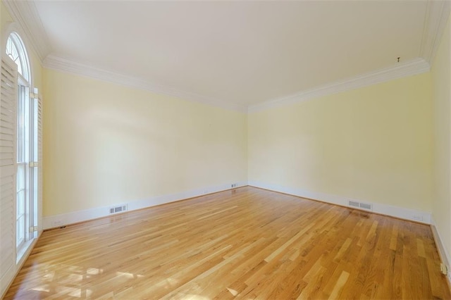 unfurnished room with crown molding and light hardwood / wood-style floors