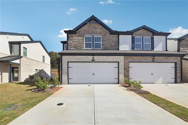 view of front of property featuring a garage and a front lawn