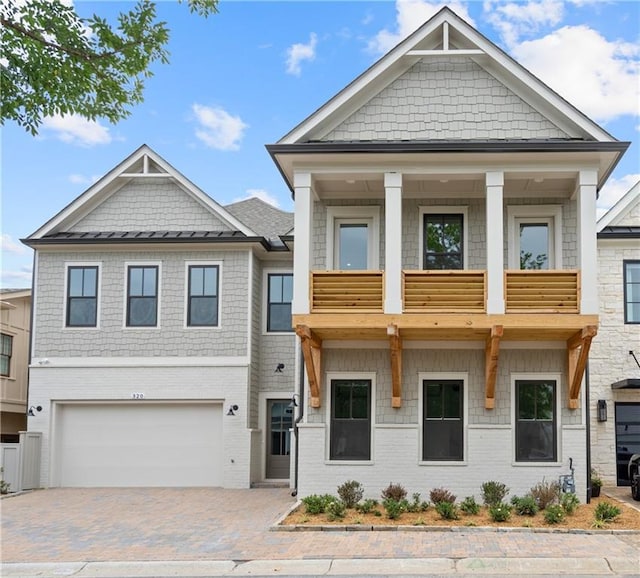 view of front of house with a garage and a balcony