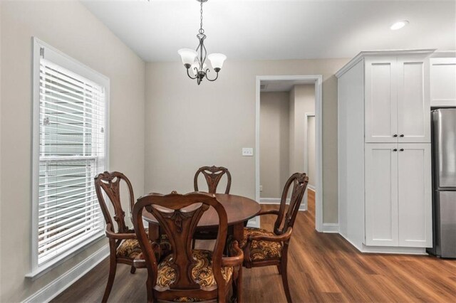 dining room with an inviting chandelier, baseboards, recessed lighting, and dark wood-style flooring