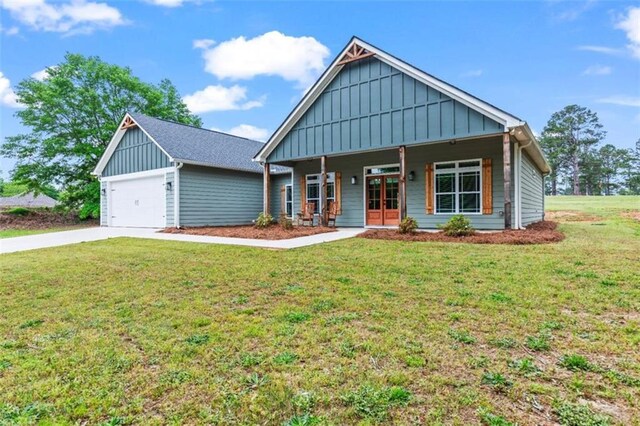 craftsman-style home with a front lawn, board and batten siding, driveway, and covered porch