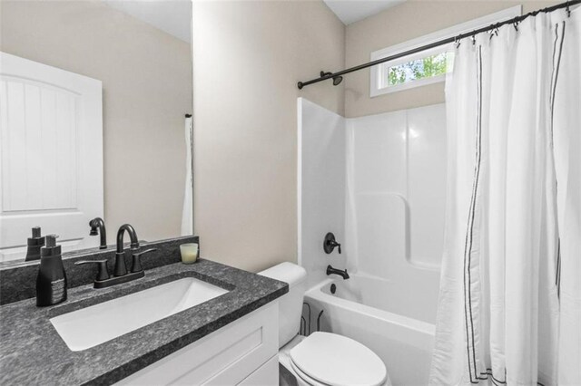 bathroom with vanity, shower / bathtub combination with curtain, and toilet