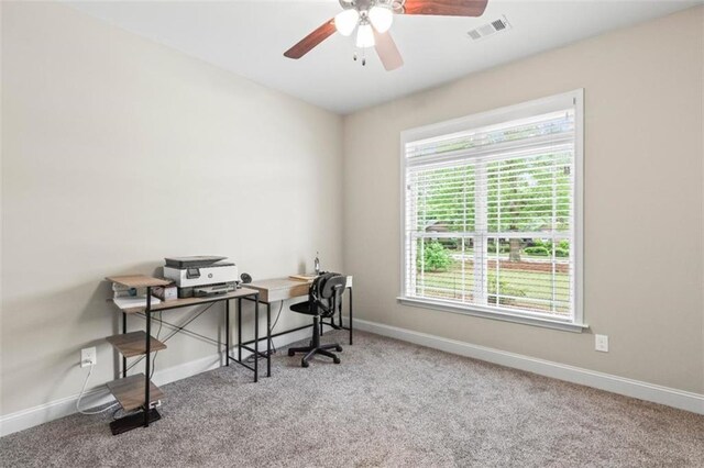 office area featuring a ceiling fan, baseboards, visible vents, and carpet