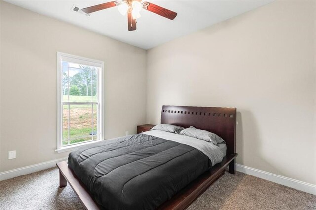 bedroom with baseboards, carpet, ceiling fan, and visible vents