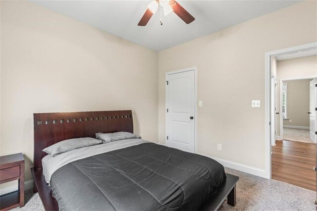 carpeted bedroom featuring baseboards and ceiling fan