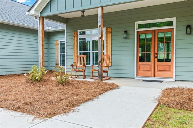entrance to property featuring covered porch and board and batten siding