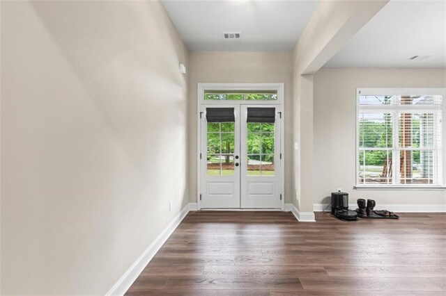 doorway to outside featuring french doors, visible vents, a healthy amount of sunlight, and wood finished floors