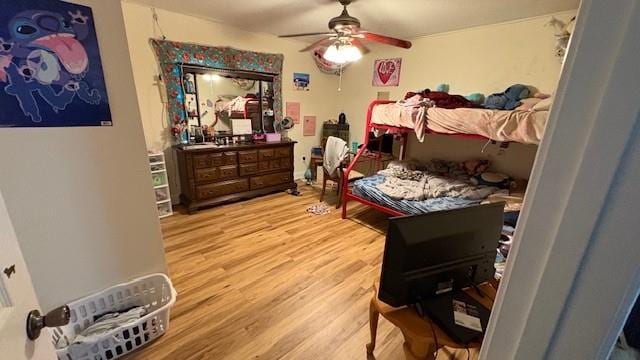 bedroom featuring a ceiling fan and wood finished floors