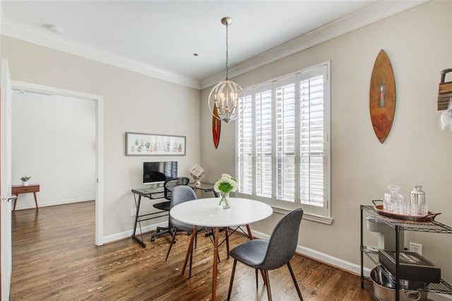 dining space featuring ornamental molding, a chandelier, a wealth of natural light, and wood finished floors