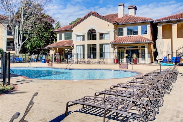 pool featuring fence and a patio