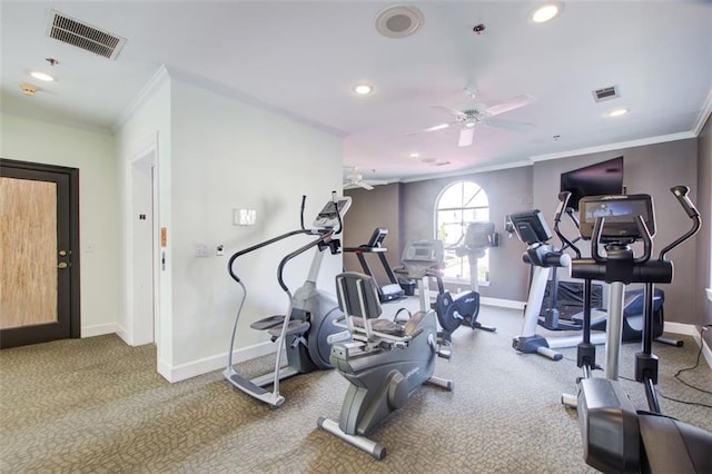 exercise room featuring ornamental molding, visible vents, and baseboards