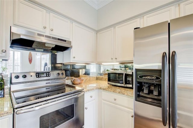 kitchen with light stone countertops, stainless steel appliances, crown molding, under cabinet range hood, and white cabinetry