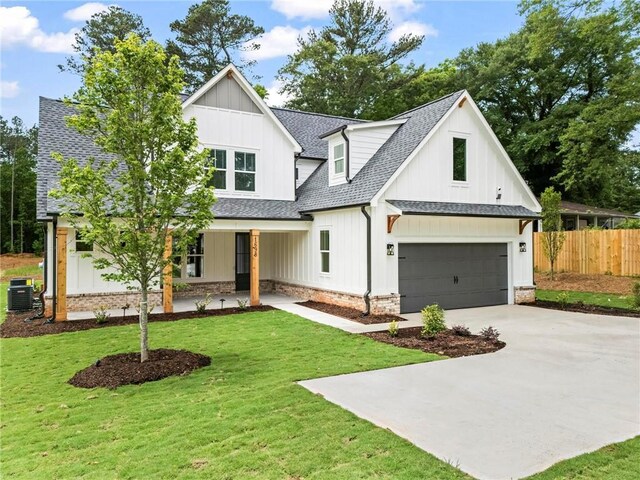1698 Cunningham Rd SW, Marietta, GA 30008 - modern inspired farmhouse featuring a porch, concrete driveway, board and batten siding, and an attached garage