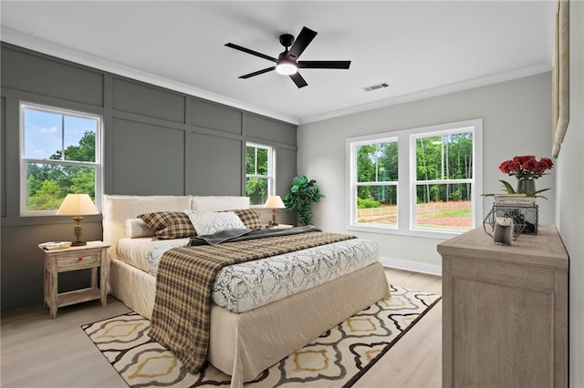 1698 Cunningham Rd SW, Marietta, GA 30008 - bedroom with light wood-type flooring, ornamental molding, and a ceiling fan