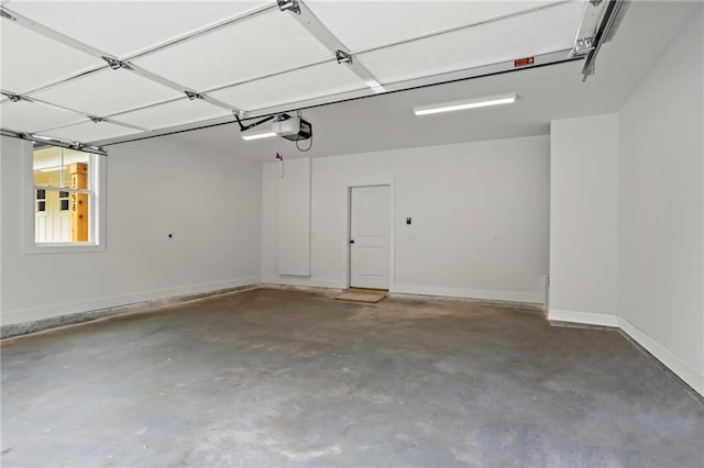 1698 Cunningham Rd SW, Marietta, GA 30008 - garage with a garage door opener and baseboards
