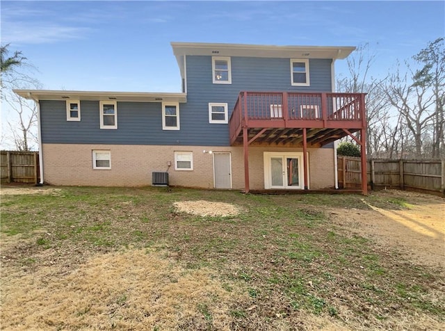 back of house with a yard, central air condition unit, and a deck