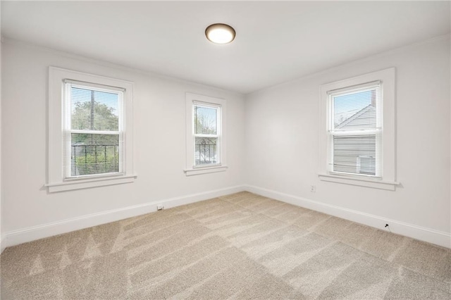 carpeted empty room featuring a healthy amount of sunlight