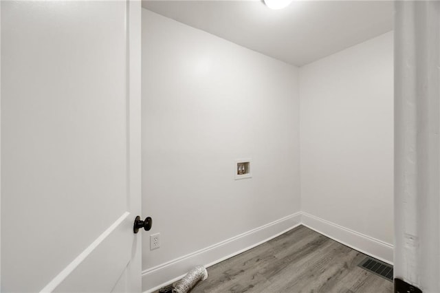 washroom with hardwood / wood-style floors and washer hookup