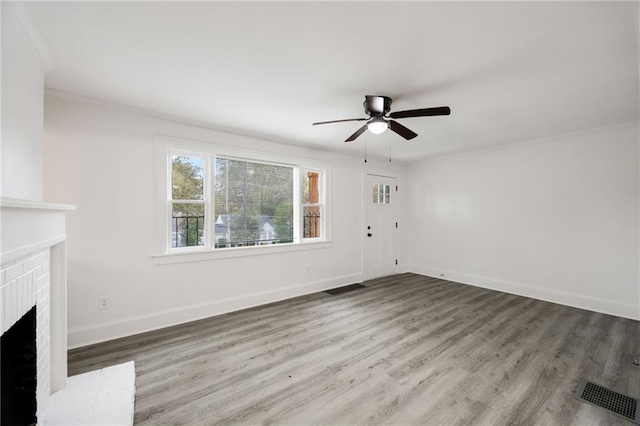 unfurnished living room featuring a fireplace, ceiling fan, hardwood / wood-style floors, and ornamental molding