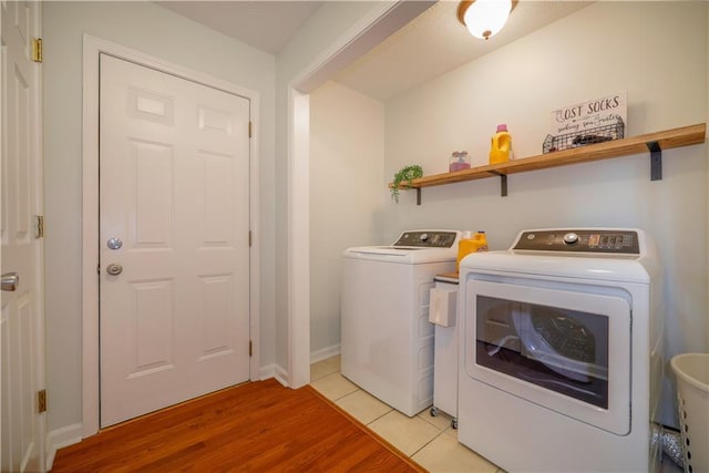 laundry area with light wood-style floors, laundry area, and independent washer and dryer