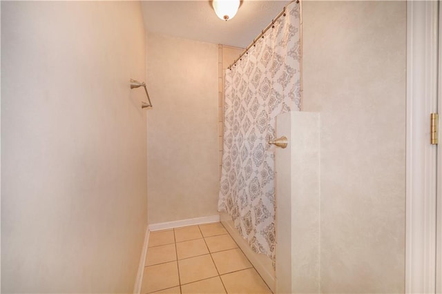 bathroom featuring a shower with shower curtain and tile patterned floors