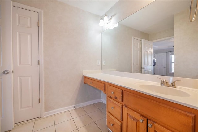 bathroom featuring vanity, baseboards, and tile patterned floors