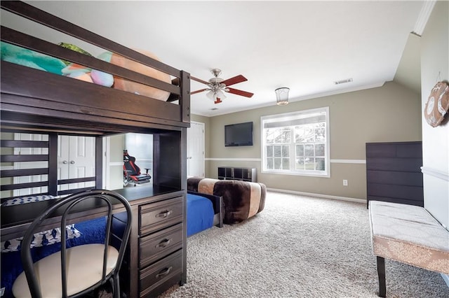 carpeted bedroom with baseboards, visible vents, vaulted ceiling, and crown molding