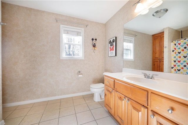 bathroom featuring curtained shower, tile patterned flooring, toilet, vanity, and baseboards