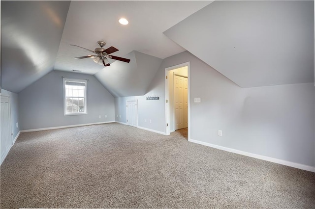 bonus room with vaulted ceiling, carpet floors, a ceiling fan, and baseboards