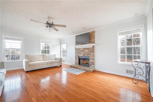 unfurnished living room with ornamental molding, wood-type flooring, visible vents, and a textured ceiling