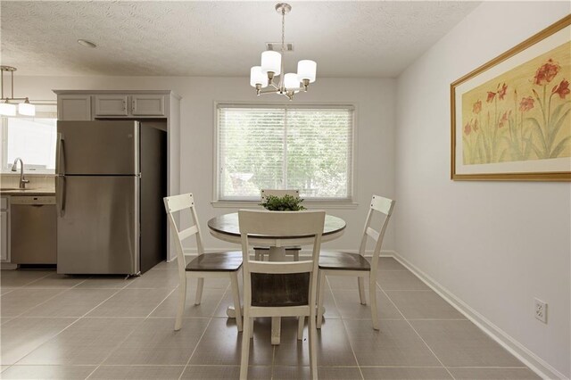340 Monivea Ln, Roswell, GA 30075 - dining space with a chandelier, a textured ceiling, light tile patterned flooring, and baseboards