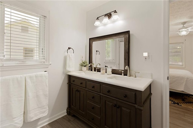 340 Monivea Ln, Roswell, GA 30075 - ensuite bathroom with double vanity, wood finished floors, baseboards, a ceiling fan, and a textured ceiling