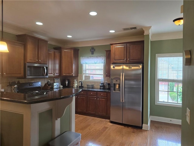 106 Trailside Way, Hiram, GA 30141 - kitchen featuring stainless steel appliances, dark countertops, ornamental molding, light wood-style floors, and backsplash