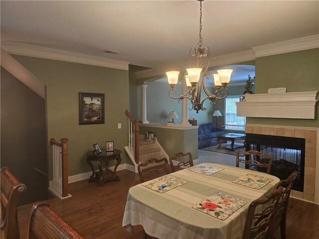 106 Trailside Way, Hiram, GA 30141 - dining room featuring dark wood-style floors, crown molding, a chandelier, baseboards, and a fireplace