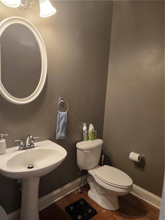106 Trailside Way, Hiram, GA 30141 - half bath featuring toilet, wood finished floors, and baseboards