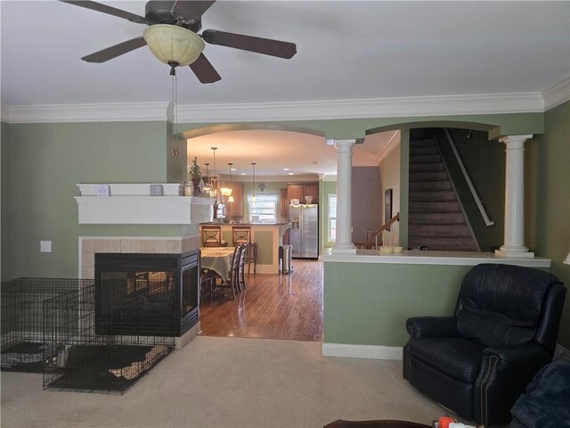 106 Trailside Way, Hiram, GA 30141 - living room with ornamental molding, ornate columns, light wood-style flooring, ceiling fan, and a tiled fireplace