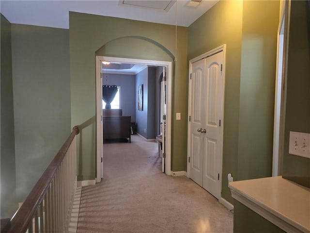 106 Trailside Way, Hiram, GA 30141 - hallway featuring light colored carpet, baseboards, arched walkways, and an upstairs landing