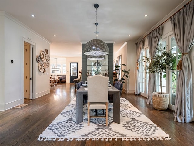 dining area with dark wood finished floors, crown molding, baseboards, and recessed lighting