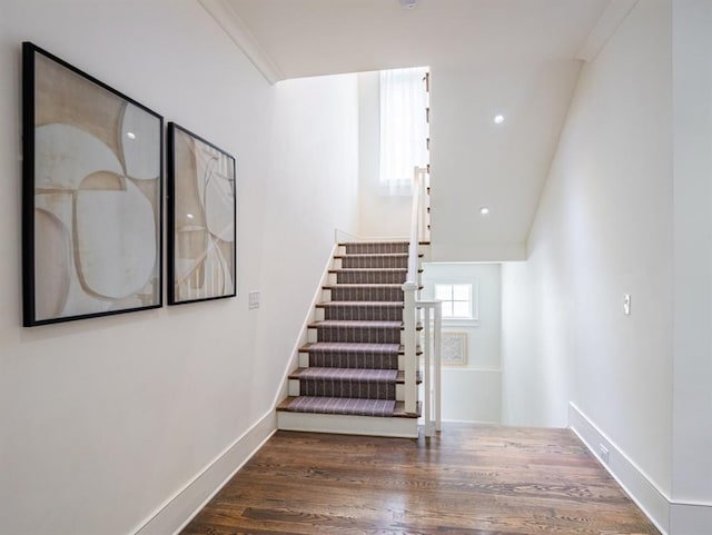 stairway featuring baseboards and wood finished floors