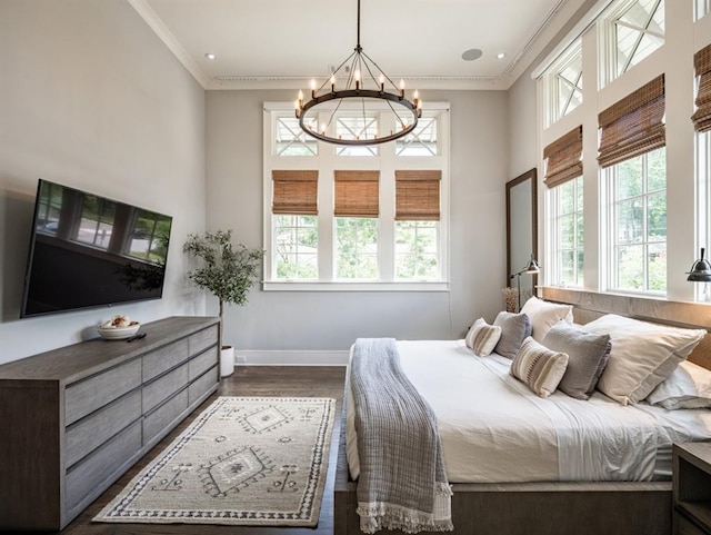 bedroom featuring a notable chandelier, multiple windows, dark wood-style floors, and crown molding