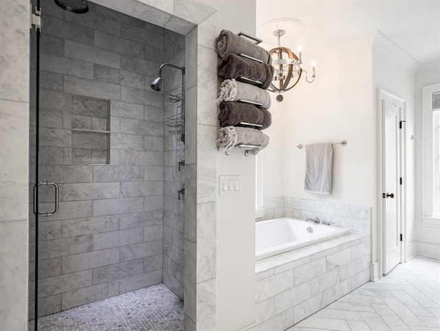 bathroom featuring ornamental molding, a chandelier, a garden tub, and a shower stall