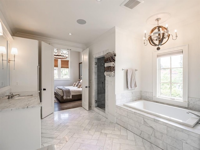 ensuite bathroom with visible vents, connected bathroom, crown molding, vanity, and a chandelier