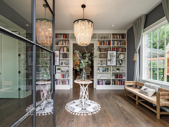 living area featuring a chandelier and wood finished floors